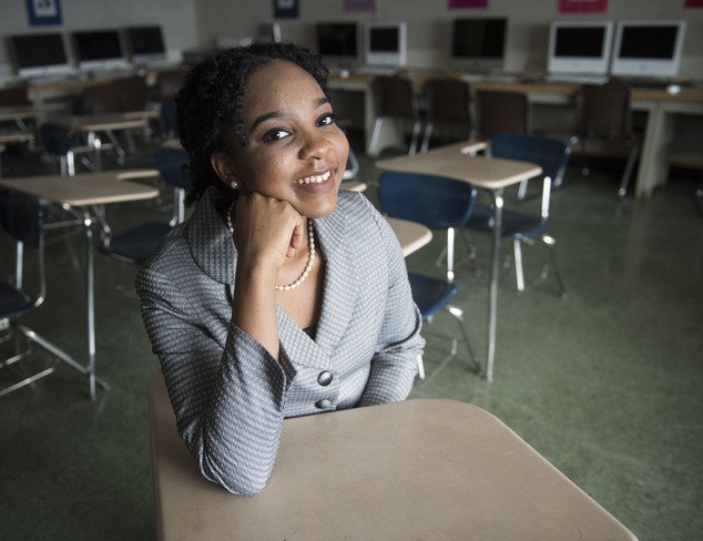 Elmont Memorial High School valedictorian Augusta Uwamanzu-Nna poses for a photo in an empty classroom on Monday, Aug. 4, 2016 in Elmont, N.Y. Uwamanzu-Nna has won acceptance to all 12 schools she applied for including all eight Ivy League universities. Its the second time in as many years a student at the suburban New York high school has been accepted at all eight Ivy League universities. (Alejandra Villa/Newsday via AP)