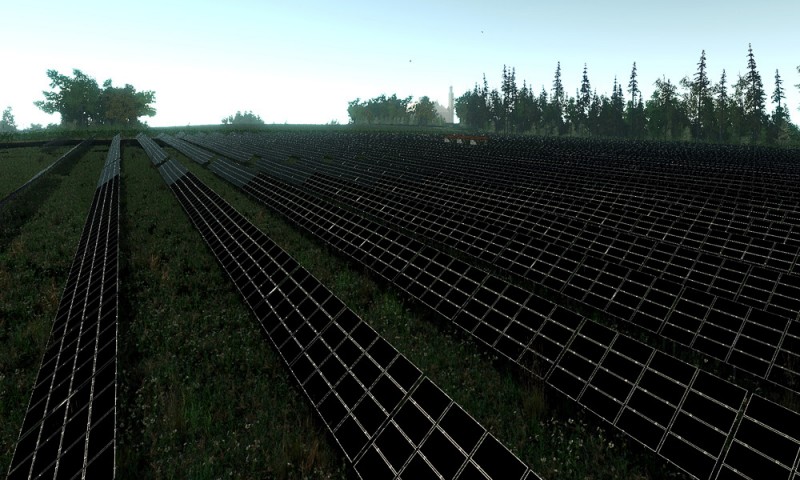Solar cell arrays lined up in a field.